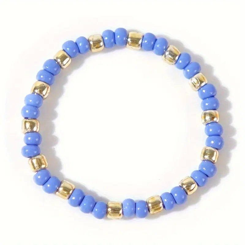 Affordable blue and gold Confettis ring by Leopoldine, crafted from shiny glass beads, laid flat on a white background – a cute stackable accessory under £10 for UK jewellery lovers.