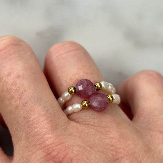 Affordable Leopoldine Amity ring with pink tourmaline and gold-tone details, styled on hand with dainty pearls – elegant UK jewellery gift idea under £50.