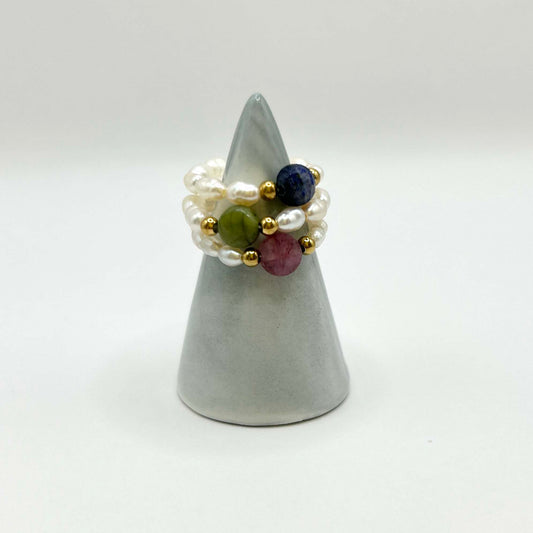 Stackable pearl rings with colourful natural stones – green jade, pink tourmaline, and deep blue lapis. Elegant beaded trio with gold accents, perfect for layering or gifting.