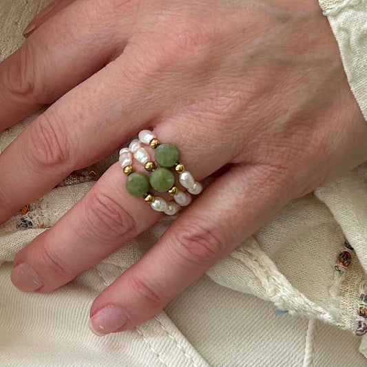 Affordable green jade stacking rings by Leopoldine with pearl and gold-tone beads, elegant UK fashion jewellery.