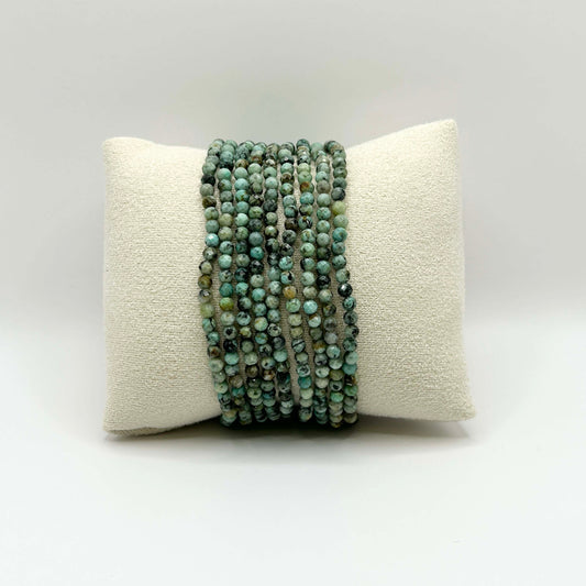 Gaia green African turquoise gemstone bracelets stacked on cushion – natural, affordable boho-style jewellery perfect for layering.
