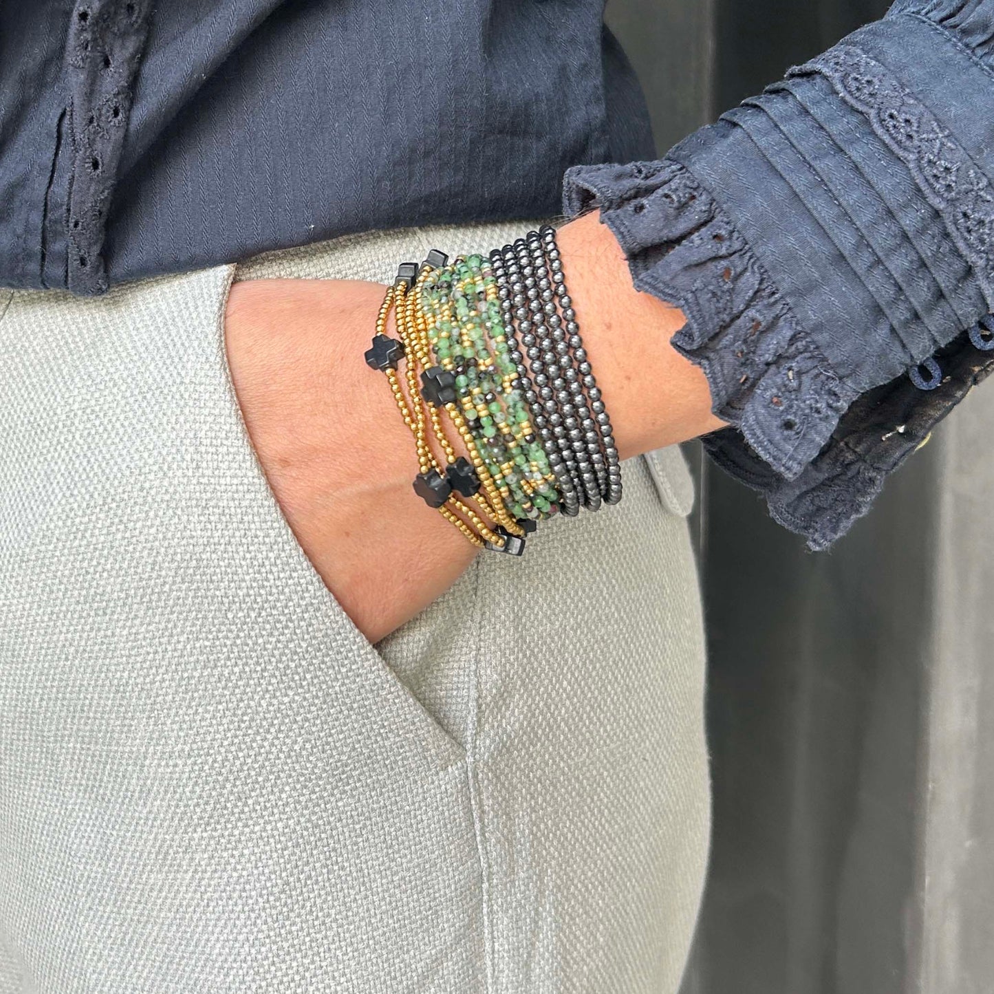 Majestic stack with Aurora hematite bracelet, green Selene wrap, and black Divine bracelet – adjustable, stackable jewellery in bold earthy tones