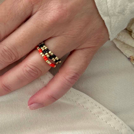 Zoomed-in view of Leopoldine Confettis ring set in black, red, and gold-tone glass beads — a fun and affordable jewellery trio for stacking.