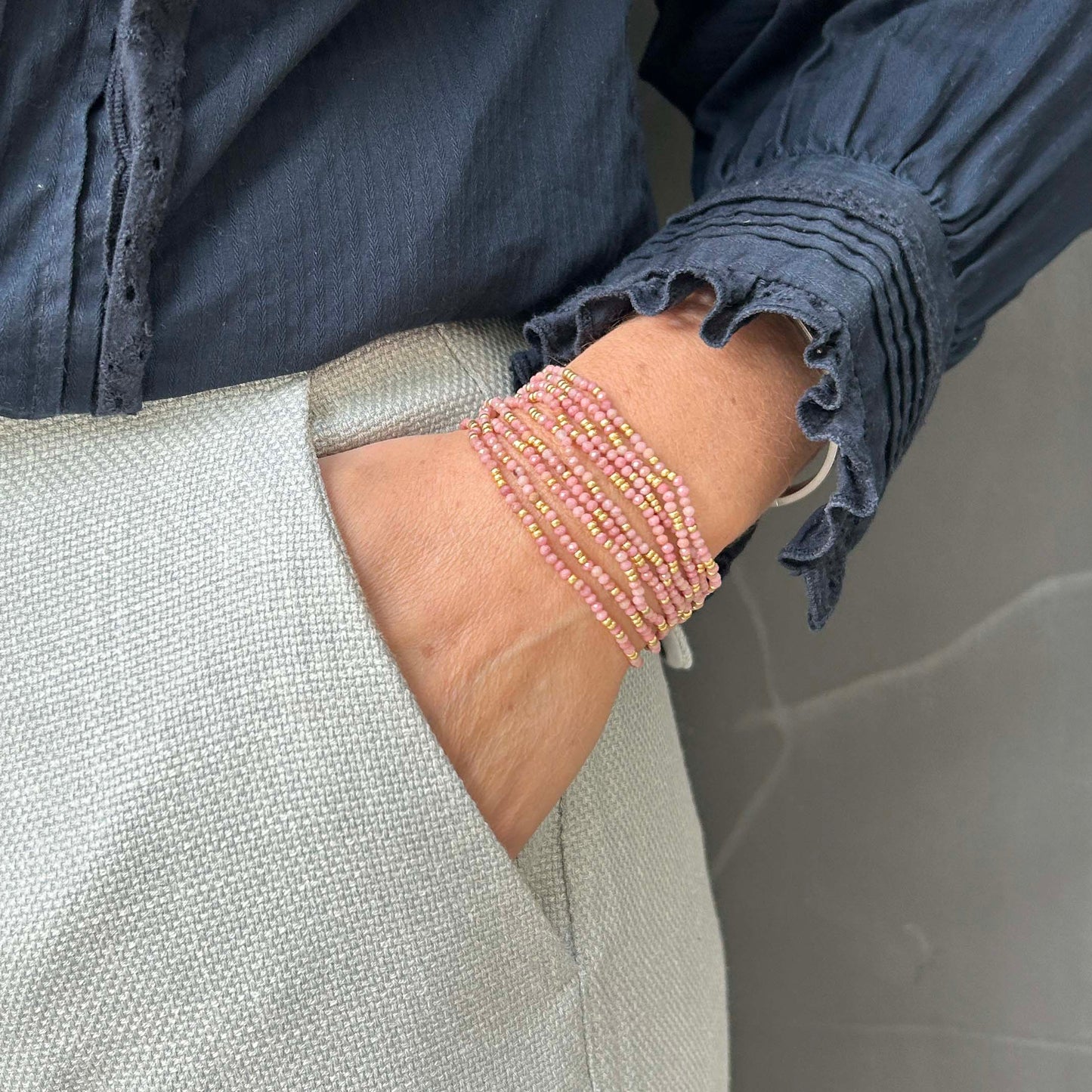 Affordable pink and gold beaded bracelet stack on wrist – chic everyday UK jewellery with a pop of colour, perfect for layering and gifting.