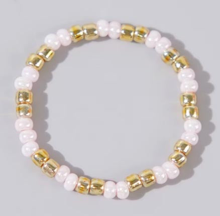 Affordable baby pink and gold Confettis ring by Leopoldine, crafted with glossy glass beads in a playful stackable style – photographed on a soft grey background, perfect under £10 jewellery gift idea.