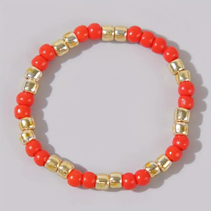 Affordable red and gold Leopoldine Confettis ring with glossy glass beads, photographed on a clean white background – perfect for stacking and gifting under £10 in the UK.