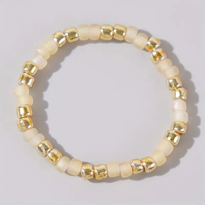 Affordable ivory and gold Confettis ring by Leopoldine, featuring smooth glass beads in a soft neutral tone – minimal, stackable and perfect for under £10 jewellery gifts in the UK.