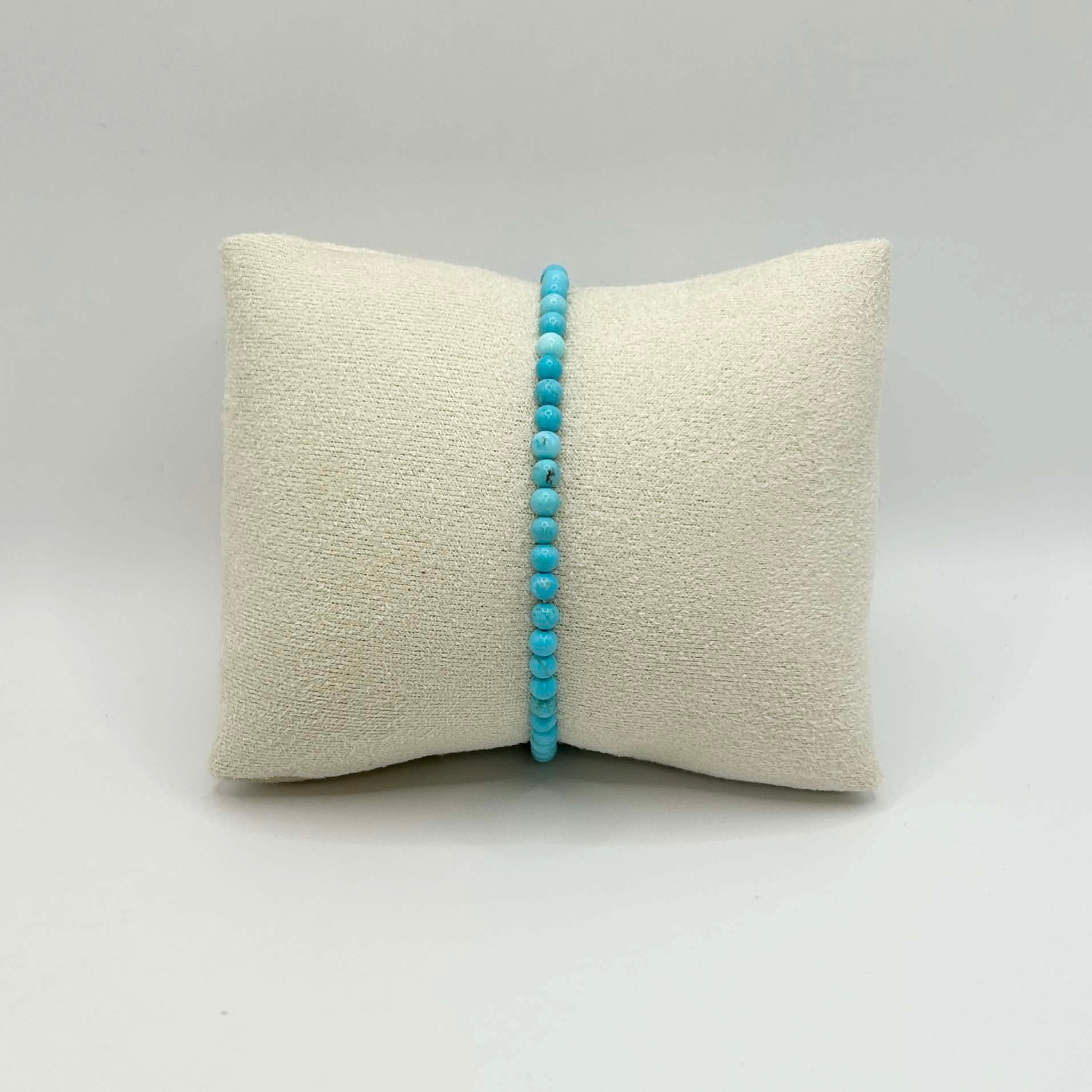 Affordable minimalist turquoise bracelet with vibrant blue beads, delicately strung for a simple yet striking statement—perfect worn solo or layered up.