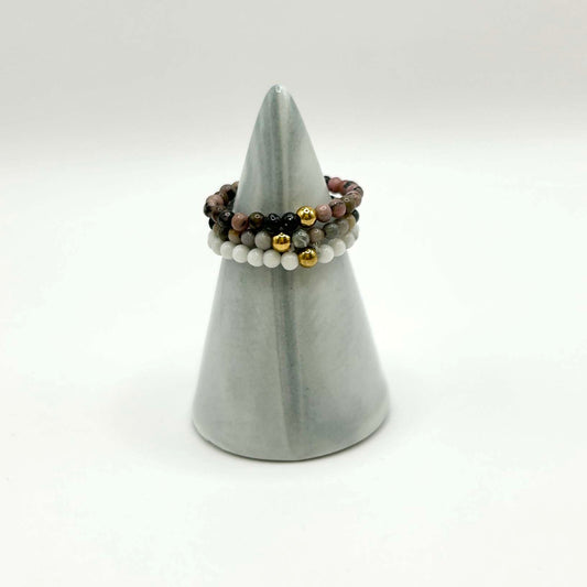 Trio of stackable gemstone rings featuring white, grey, and pink tones with gold beads. Minimalist and affordable UK jewellery, perfect for layering or gifting with love.