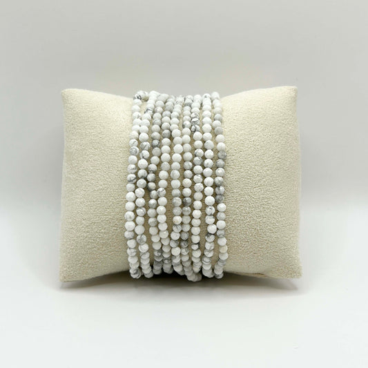 Gaia white turquoise gemstone stacking bracelets displayed on neutral cushion – minimalist, boho-chic jewellery, perfect for layering and affordable gifts.