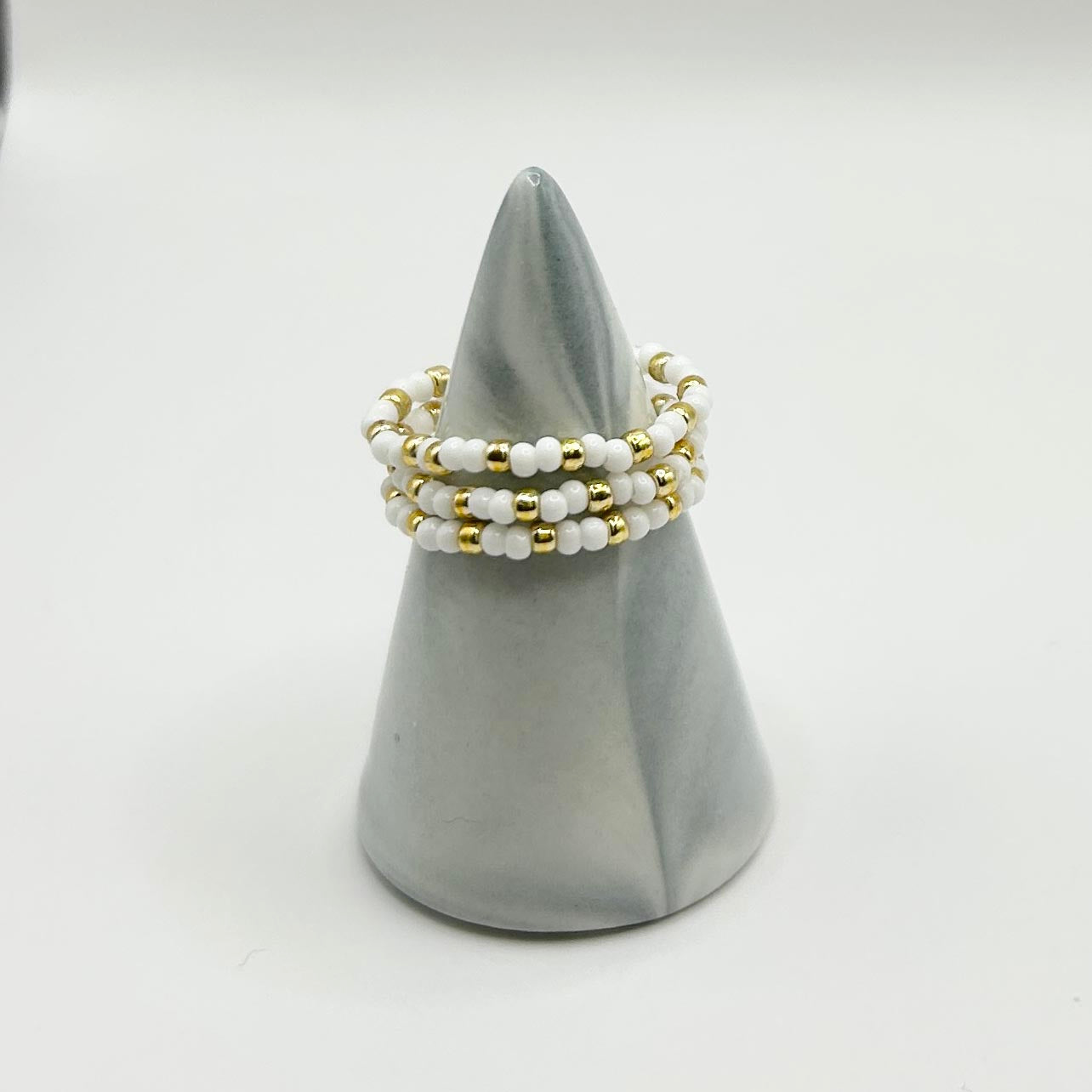 Set of three Leopoldine Confettis rings in white and gold glass beads, stackable fashion jewellery under £10 UK.
