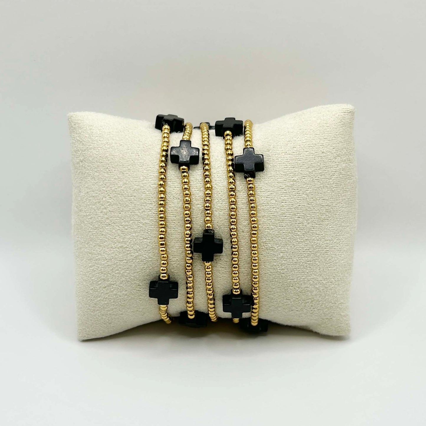 Leopoldine Divine bracelet featuring five black cross stones on gold-plated stainless steel beads – minimalist yet bold stacking bracelet, perfect affordable UK gift with a touch of modern spirituality.