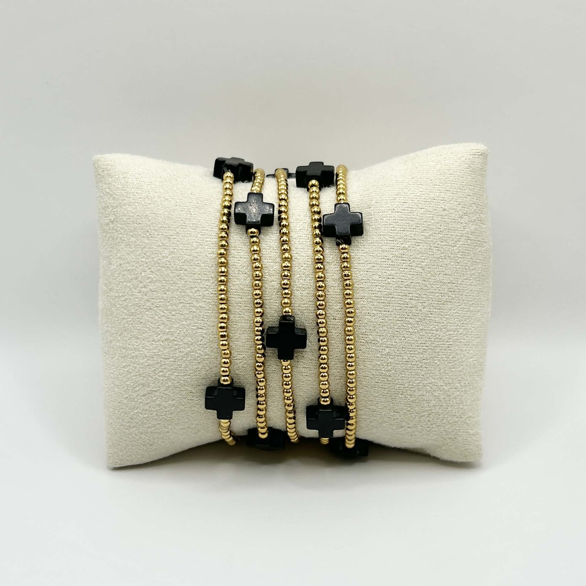 Leopoldine Divine bracelet featuring five black cross stones on gold-plated stainless steel beads – minimalist yet bold stacking bracelet, perfect affordable UK gift with a touch of modern spirituality.