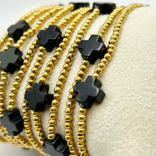 Close-up of Leopoldine Divine bracelet featuring black cross beads and gold stainless steel pearls – elegant and affordable stacking bracelet perfect for gifting or everyday UK style.