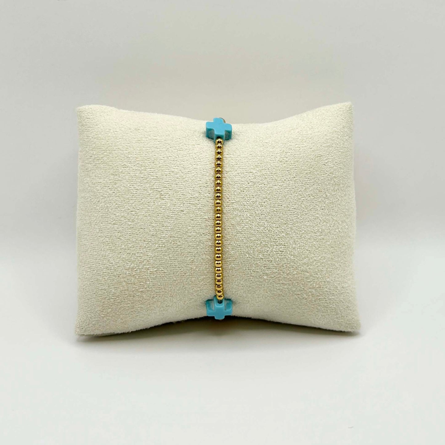 Minimalist turquoise cross bracelet by Leopoldine Divine – dainty and elegant with golden stainless steel beads, perfect for everyday stacking or a sweet spiritual gift under £30.