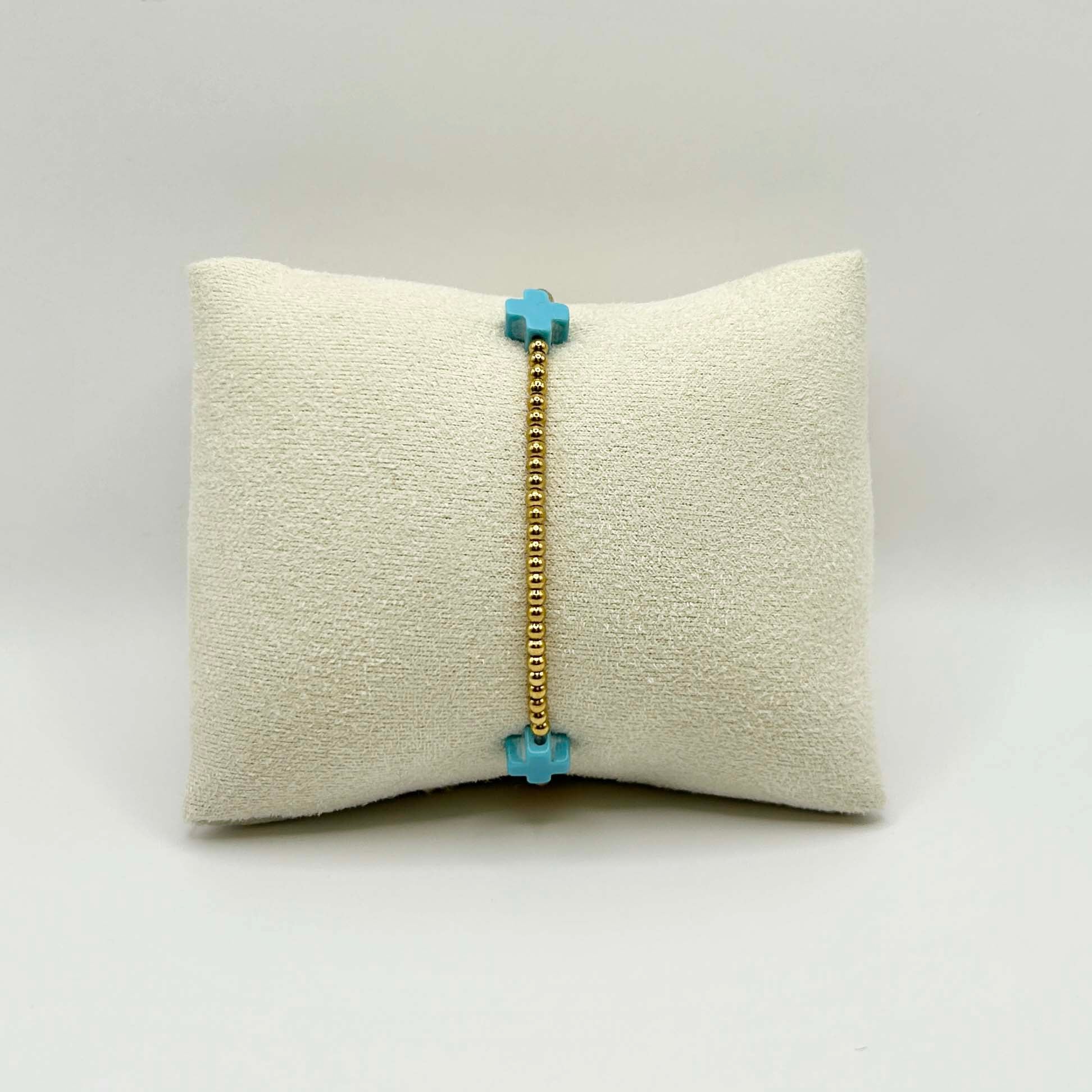 Minimalist turquoise cross bracelet by Leopoldine Divine – dainty and elegant with golden stainless steel beads, perfect for everyday stacking or a sweet spiritual gift under £30.