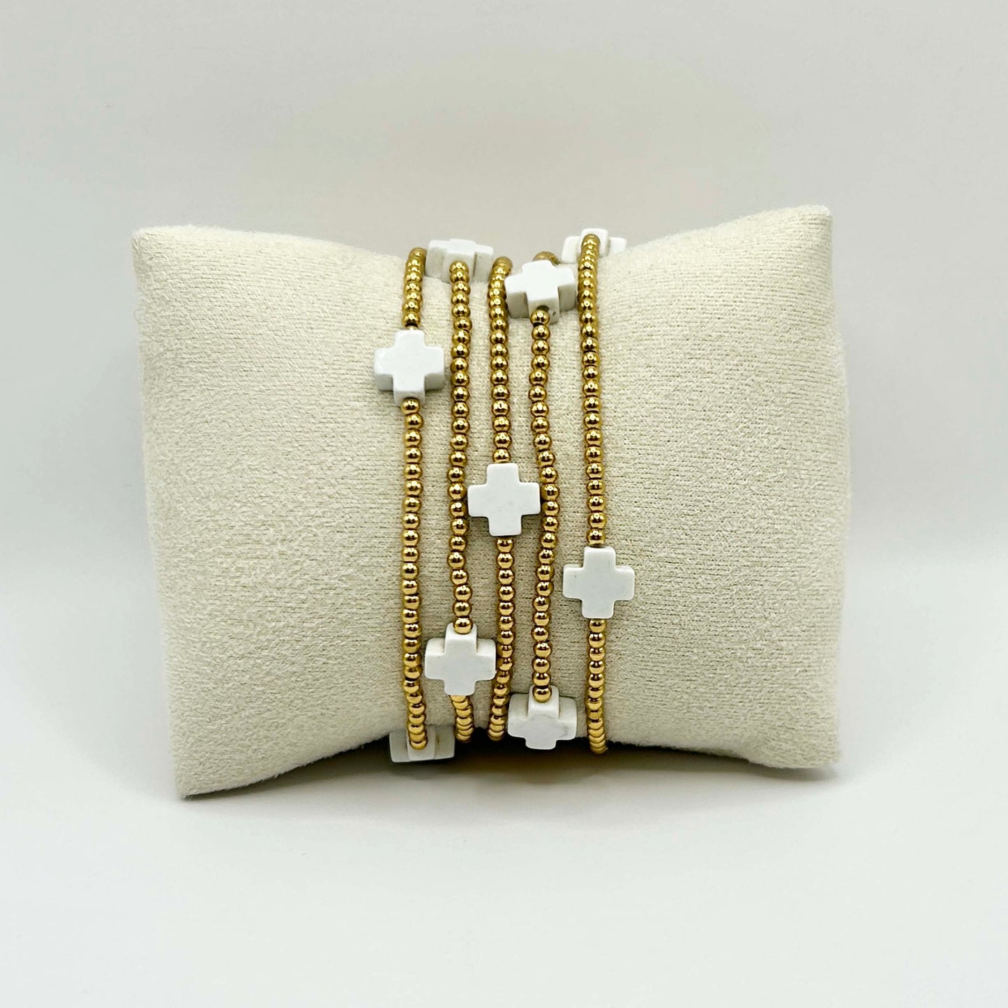 Elegant close-up of the Leopoldine Divine bracelet featuring a trio of white cross beads with subtle gold accents – minimalist, affordable UK jewellery perfect for everyday layering.