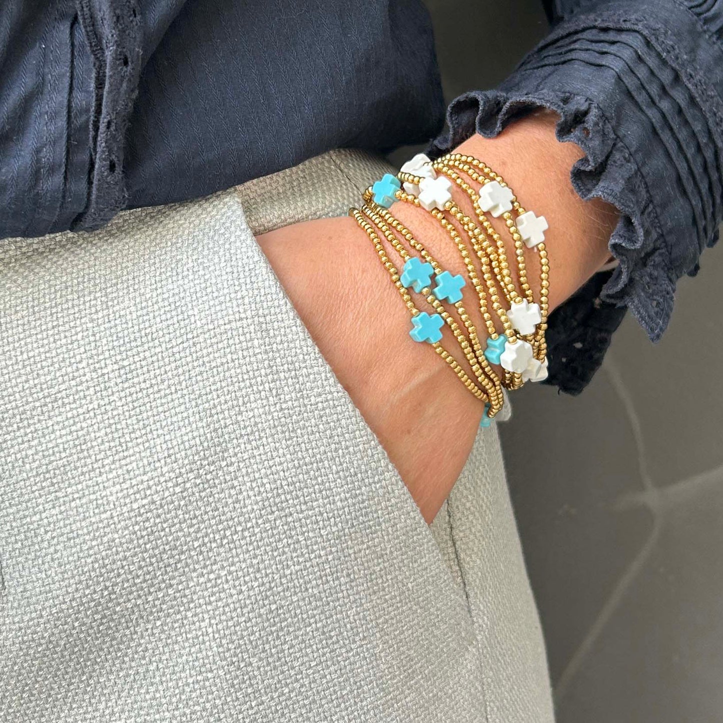 Affordable Divine stack bracelet with turquoise and white cross beads – delicate gold beaded jewellery, lightweight and adjustable for everyday layering.