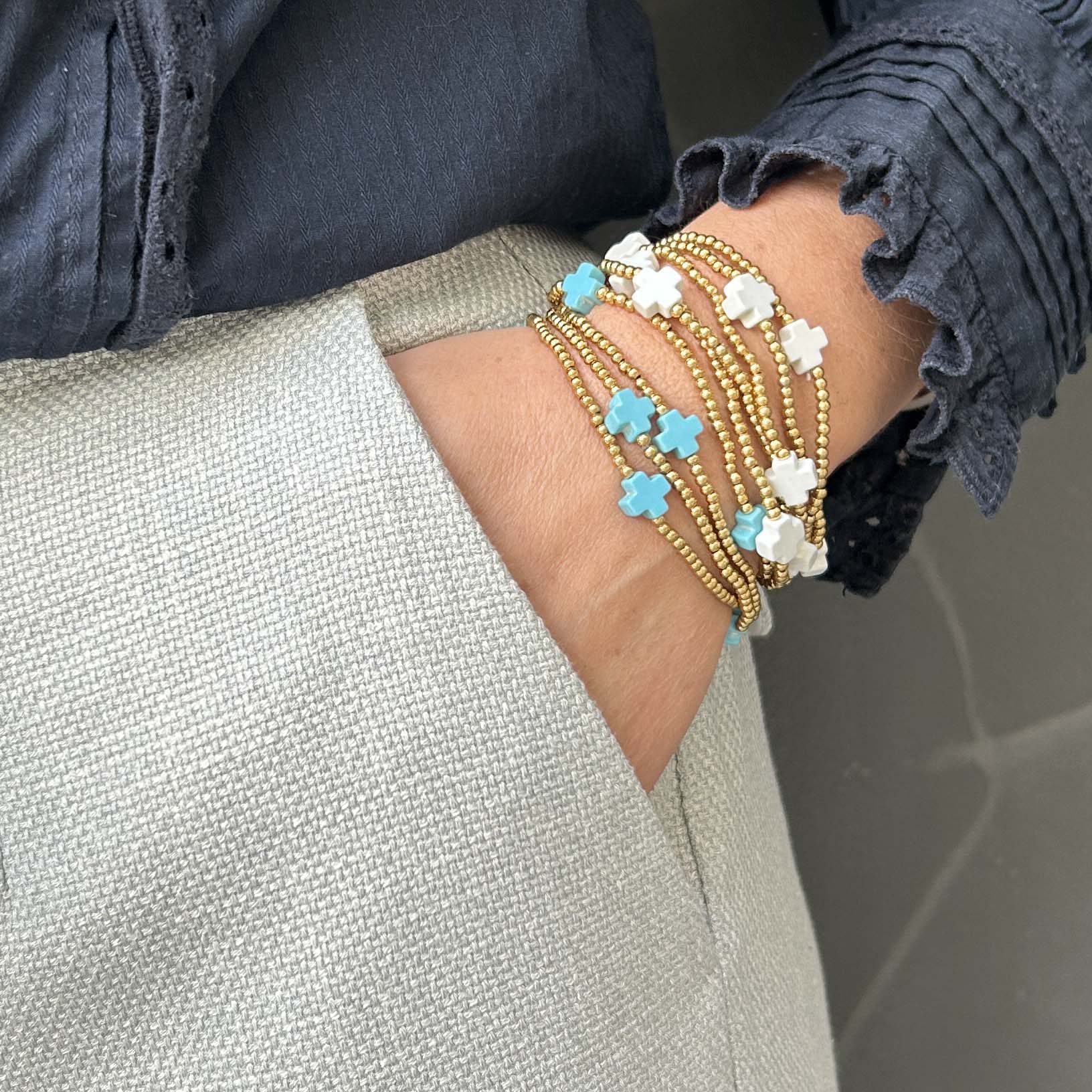 Affordable Divine stack bracelet with turquoise and white cross beads – delicate gold beaded jewellery, lightweight and adjustable for everyday layering.