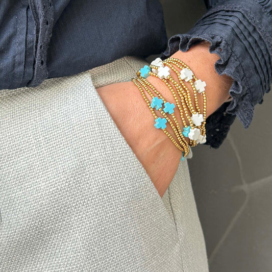 Affordable Divine stack bracelet with turquoise and white cross beads – delicate gold beaded jewellery, lightweight and adjustable for everyday layering.
