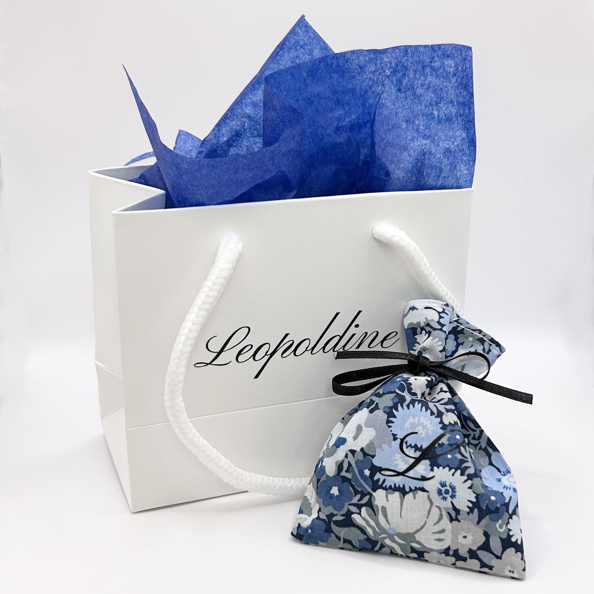 Leopoldine sustainable jewellery packaging – Liberty of London fabric pouch and branded paper bag, reusable and eco-conscious alternative to boxes