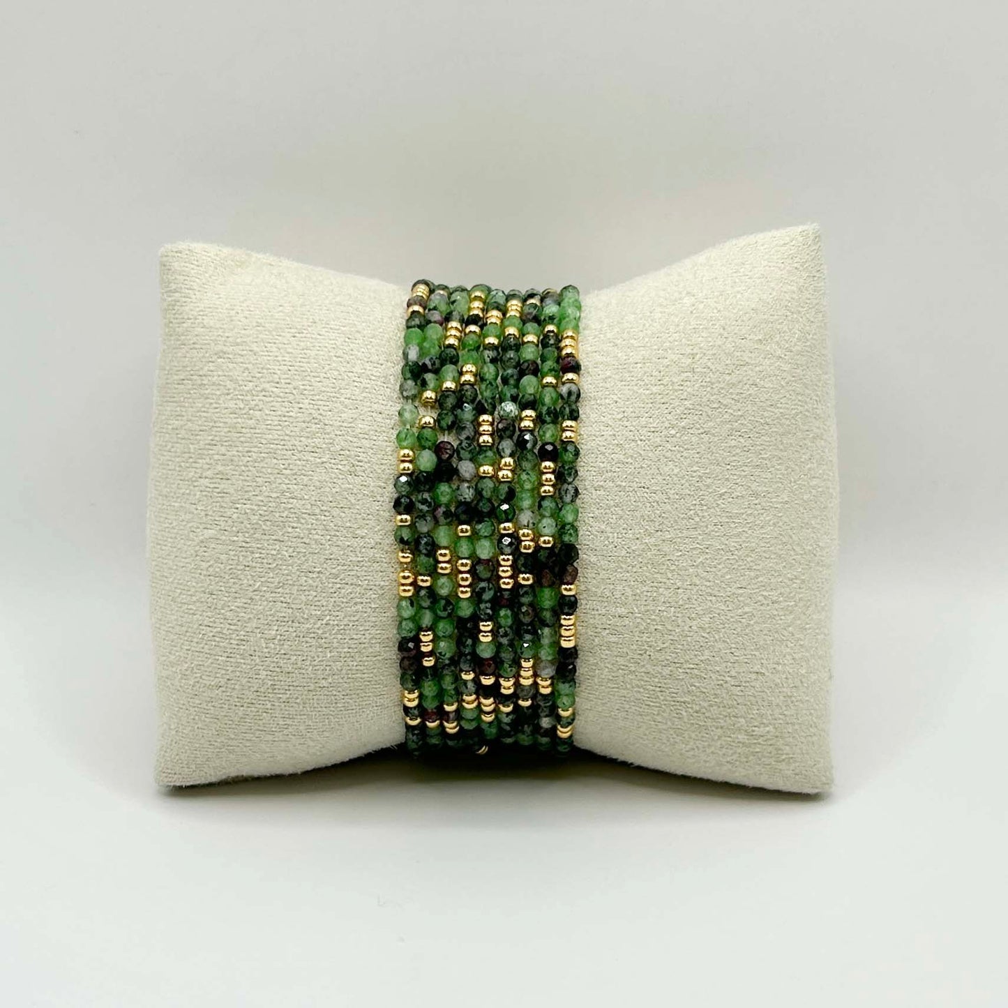 Front view of the Leopoldine Selene green gemstone bracelet with shimmering gold accents, stacked on a neutral display pillow – vibrant, nature-inspired and perfect for layering.