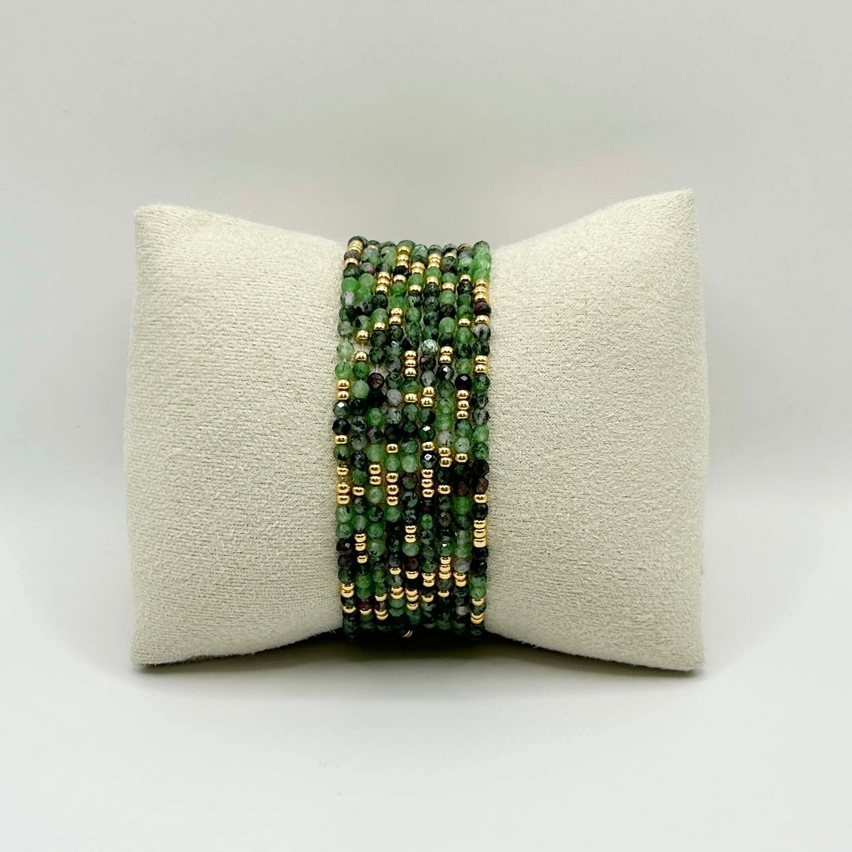 Front view of the Leopoldine Selene green gemstone bracelet with shimmering gold accents, stacked on a neutral display pillow – vibrant, nature-inspired and perfect for layering.